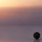 Calm water and a stack of smooth stones