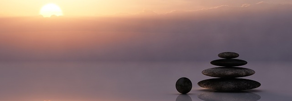 Calm water and a stack of smooth stones