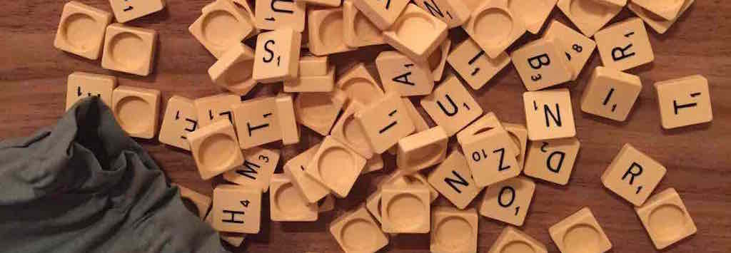 Scrabble tiles spilling from a bag
