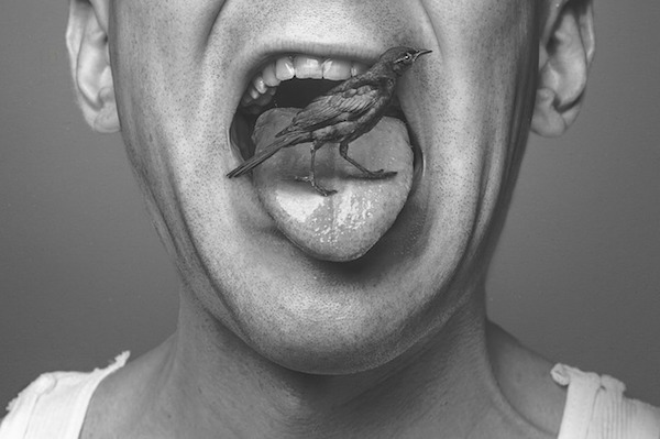 Man with a bird on his tongue