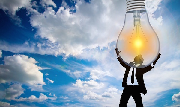 Man holding a large lightbulb